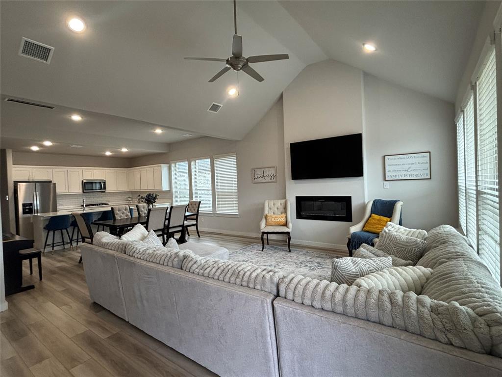 2029 Dovedale Drive Forney, TX 75126 - Photo 7 of 18 a living room with furniture a fireplace and a flat screen tv