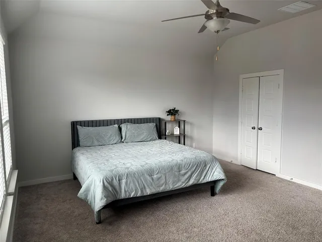 a bed sitting in a bedroom next to a window