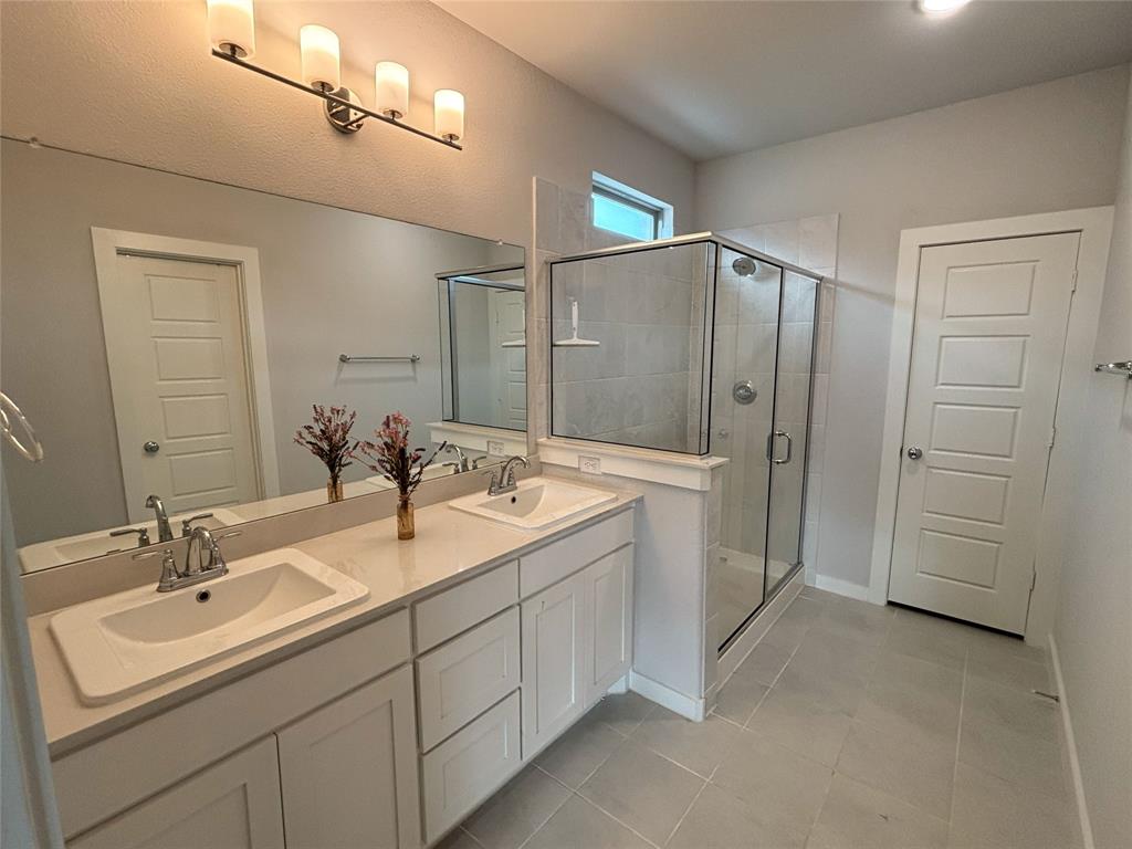 2029 Dovedale Drive Forney, TX 75126 - Photo 10 of 18 a bathroom with a double vanity sink mirror and shower