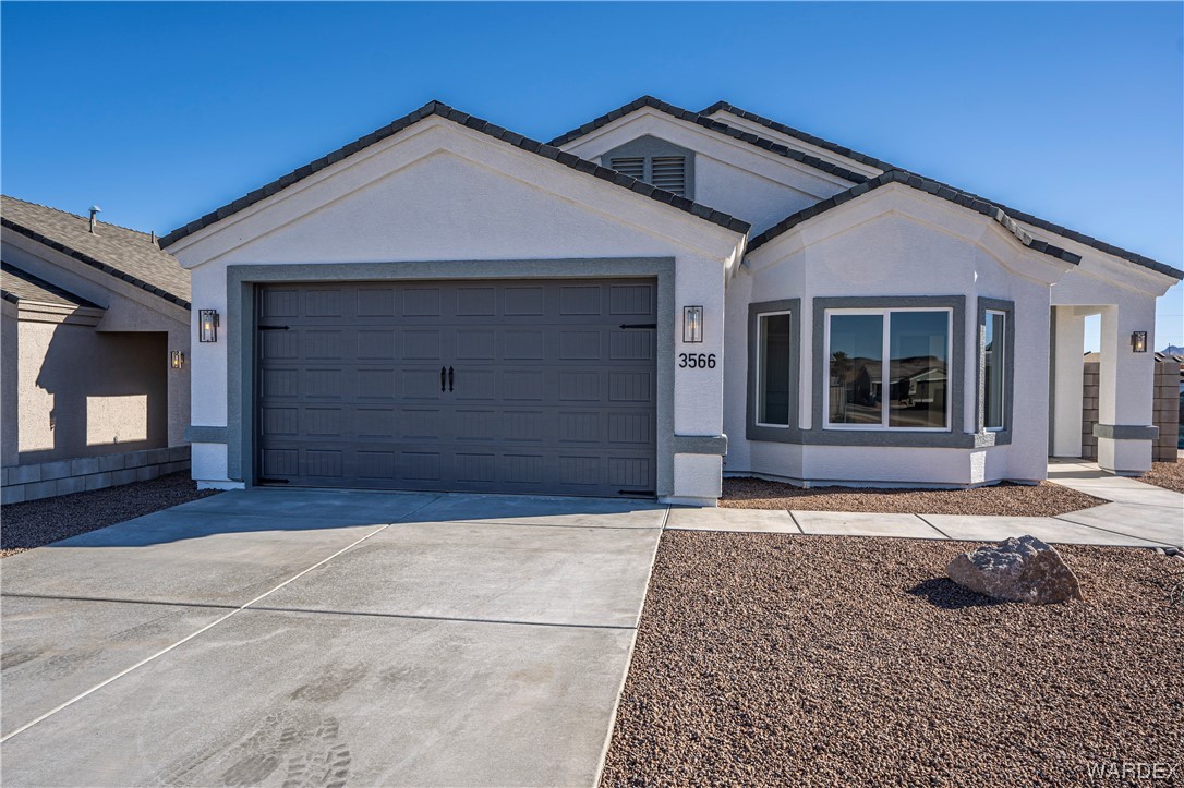 3566 North Kenneth Road Kingman, AZ 86409 - Photo 3 of 35 a front view of a house with a garage