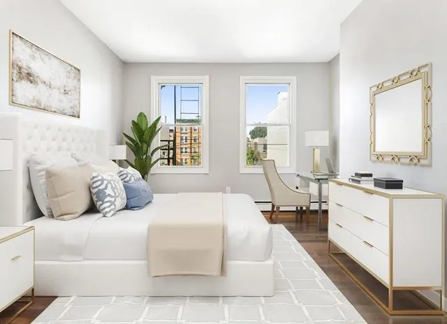 a spacious bedroom with a large bed and a couch