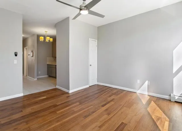wooden floor in an empty room with a window