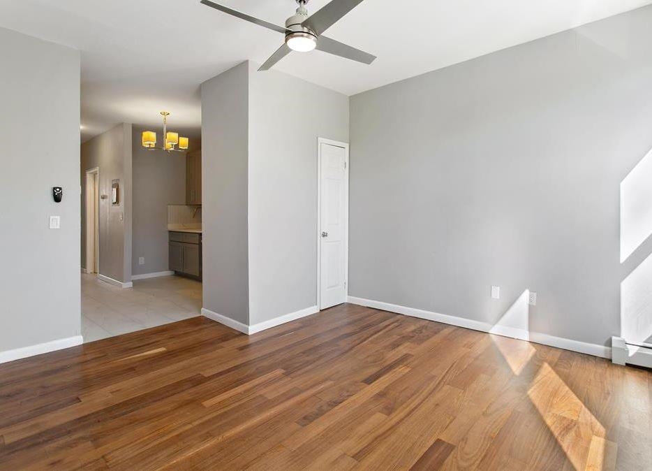 475 Palisade Avenue, Unit 4 Jersey City, NJ 07307 - Photo 11 of 16 wooden floor in an empty room with a window
