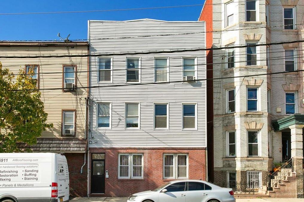 475 Palisade Avenue, Unit 4 Jersey City, NJ 07307 - Photo 16 of 16 a front view of a building with a lot of windows