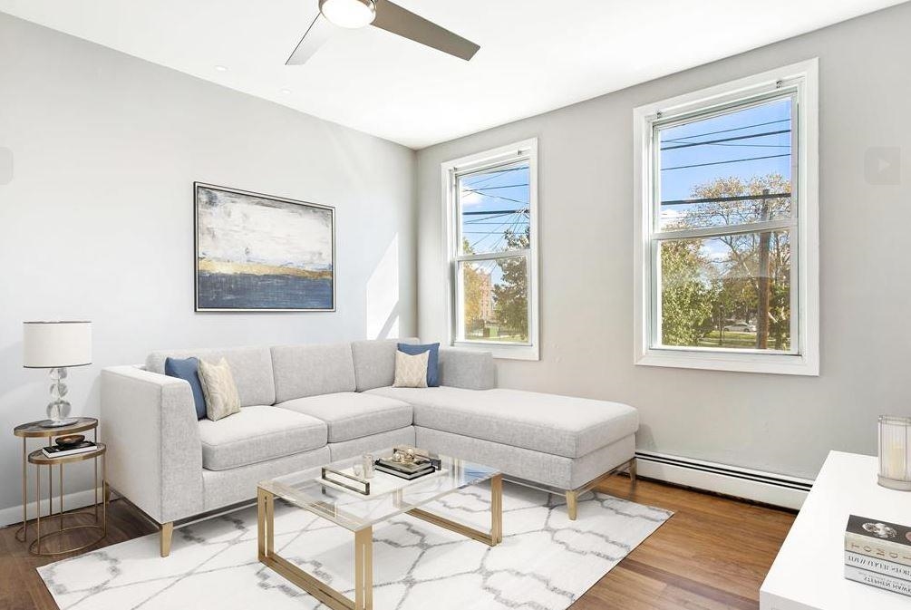 475 Palisade Avenue, Unit 4 Jersey City, NJ 07307 - Photo 2 of 16 a living room with furniture and a window