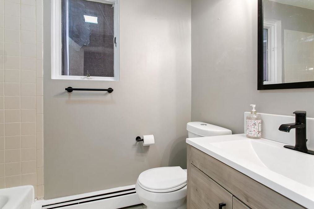 475 Palisade Avenue, Unit 4 Jersey City, NJ 07307 - Photo 6 of 16 a bathroom with a sink a toilet and mirror
