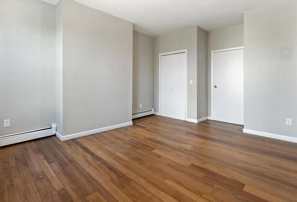 475 Palisade Avenue, Unit 4 Jersey City, NJ 07307 - Photo 9 of 16 a view of an empty room with wooden floor