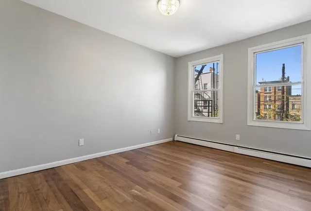 a view of room with window and hardwood floor