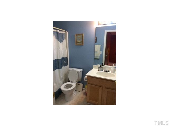3100 Marcony Way Raleigh, NC 27610 - Photo 11 of 14 a bathroom with a sink and a mirror