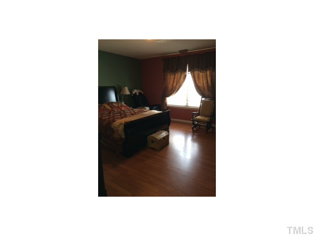3100 Marcony Way Raleigh, NC 27610 - Photo 12 of 14 a living room with a chair and a potted plant