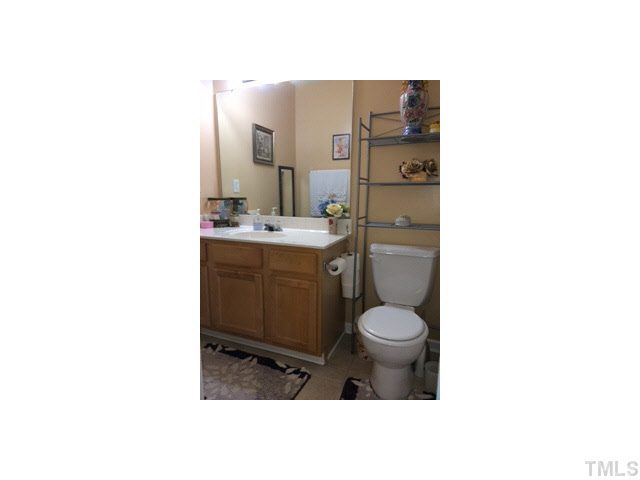 3100 Marcony Way Raleigh, NC 27610 - Photo 13 of 14 a bathroom with a toilet sink and mirror