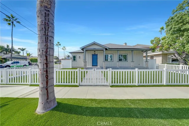a front view of a house with a garden and deck
