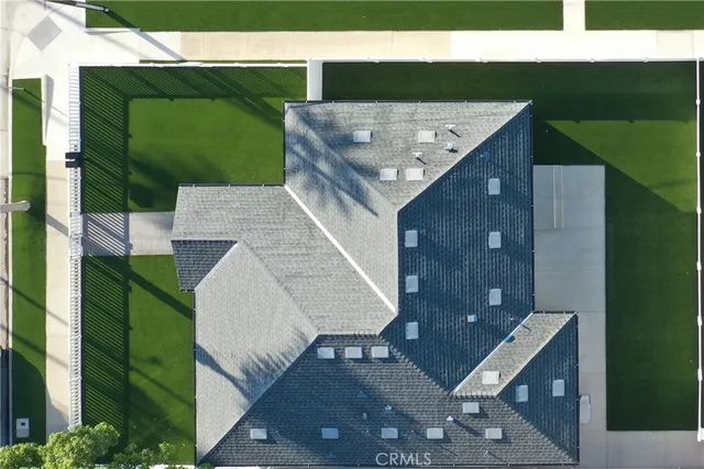 an aerial view of residential houses with city view