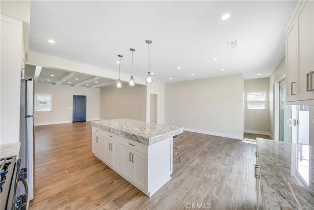 a large white kitchen with a large sink oven and refrigerator