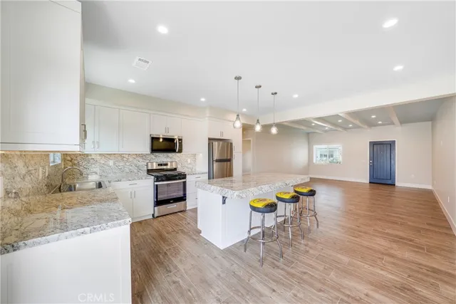 a kitchen with a sink and a stove top oven