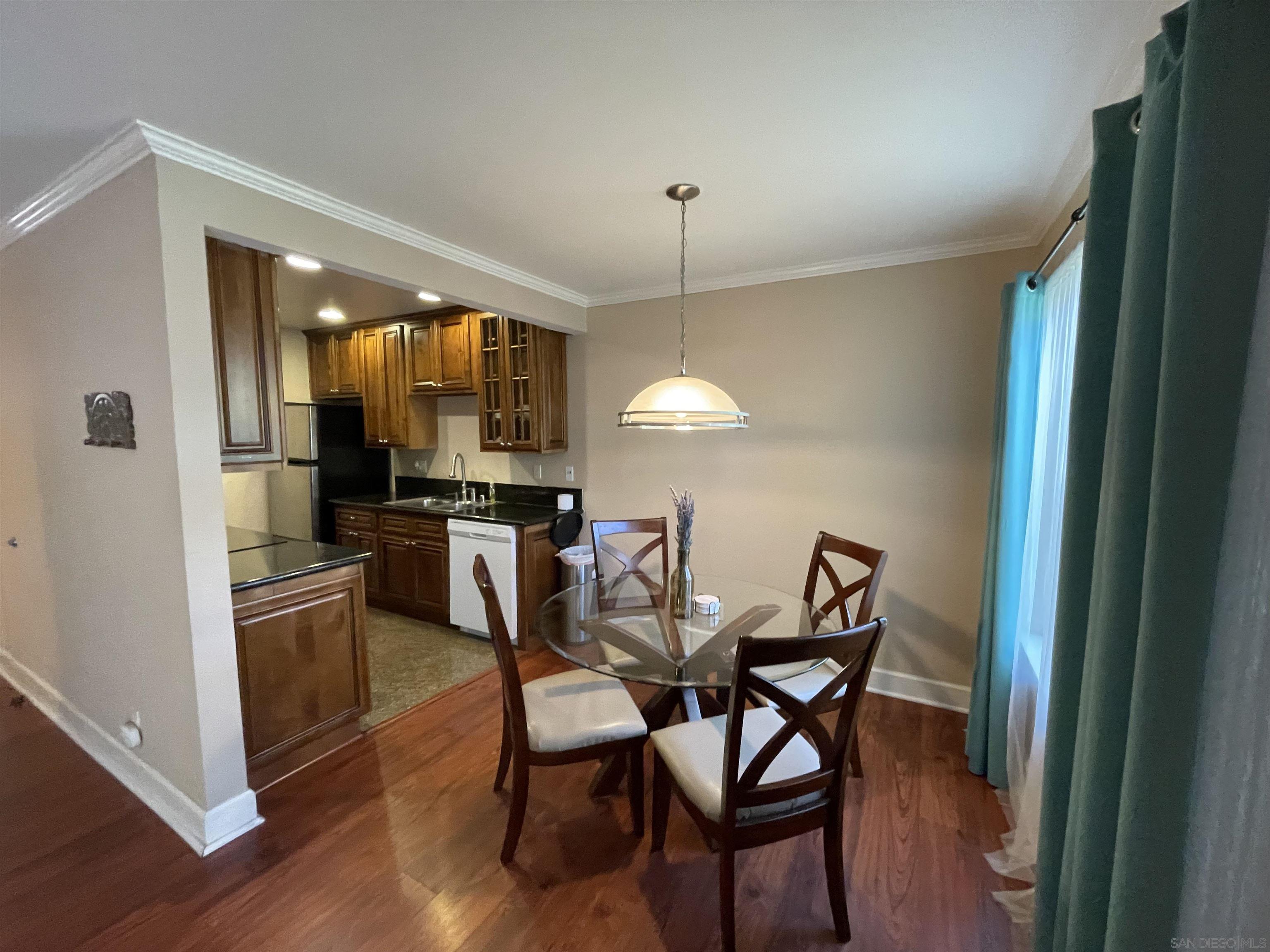 8529 Villa La Jolla Drive, Unit J La Jolla, CA 92037 - Photo 1 of 21 a view of a dining room with furniture and wooden floor
