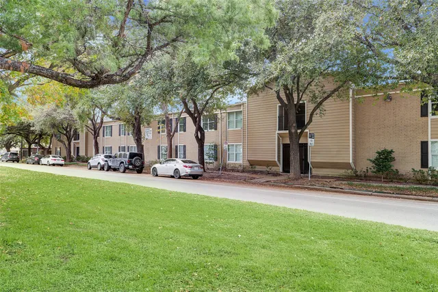 a view of a street with houses and trees