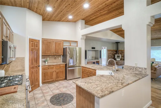 a kitchen with stainless steel appliances granite countertop a sink stove and cabinets