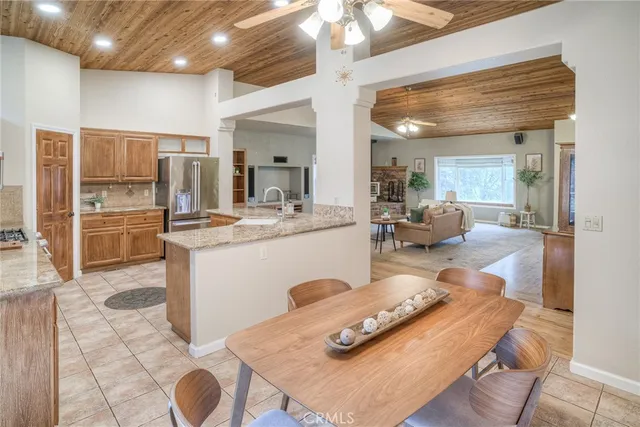 a living room with furniture and a kitchen area