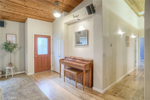 a view of an empty room with a chandelier fan