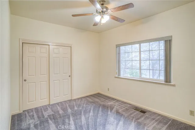 a bathroom with a toilet sink vanity granite and shower
