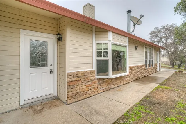 a living room with furniture a flat screen tv and a table