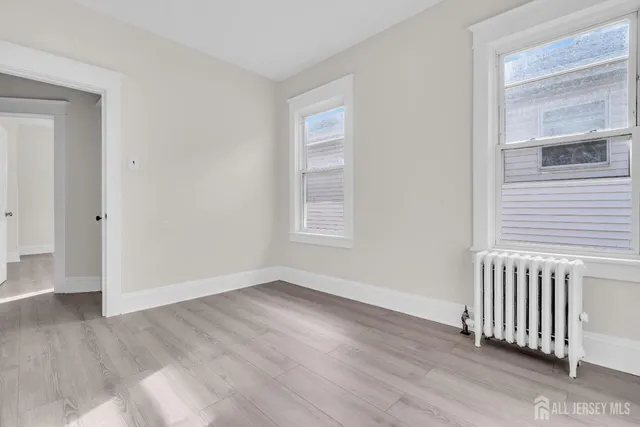 a view of a livingroom with wooden floor and window