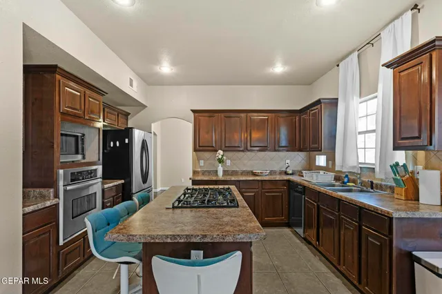 a kitchen with a refrigerator and a stove