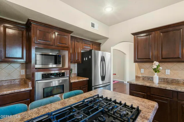 a view of a dining room with furniture a chandelier and wooden floor