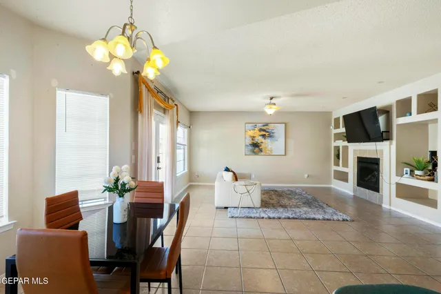 a utility room with granite countertop a sink a stove and cabinets
