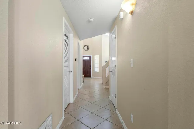 a bedroom with a bed and a flat tv screen on a dresser