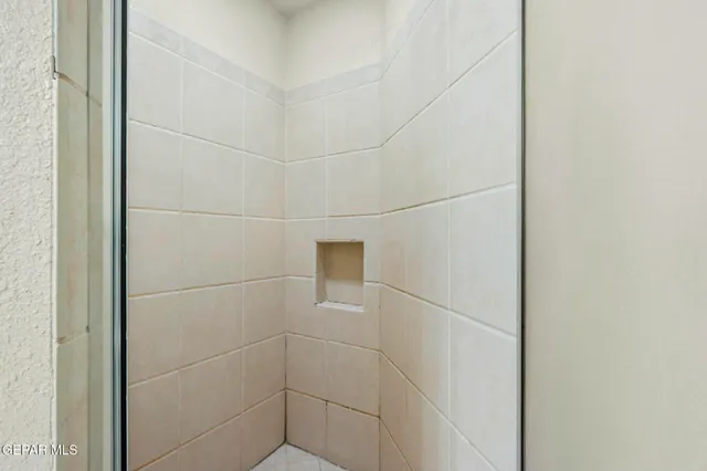 a bathroom with a double vanity sink mirror and shower