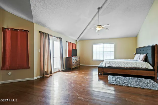 a patio with a table and chairs and a barbeque