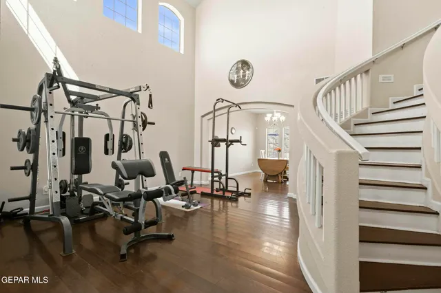 a view of a dining room with furniture a chandelier and wooden floor