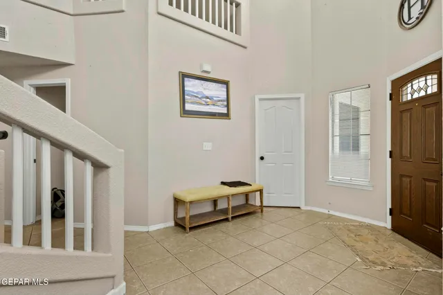 a view of a dining room with furniture a chandelier and wooden floor