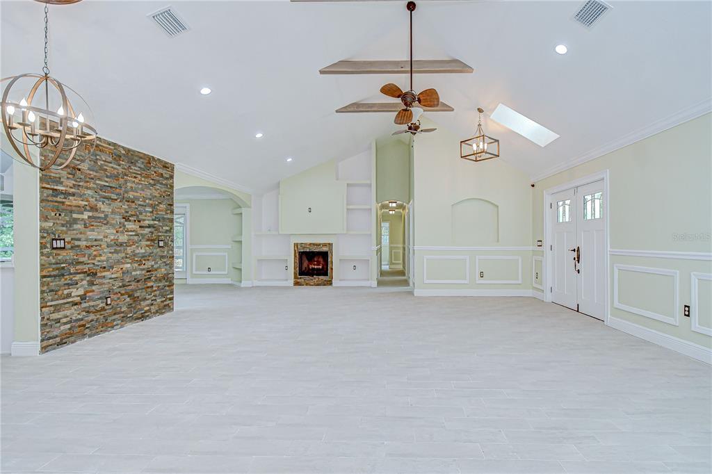 1931 Jaudon Road Dover, FL 33527 - Photo 11 of 50 a view of empty room with a fireplace and fan