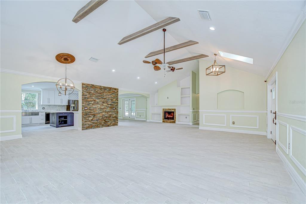 1931 Jaudon Road Dover, FL 33527 - Photo 12 of 50 an empty room with fireplace and windows