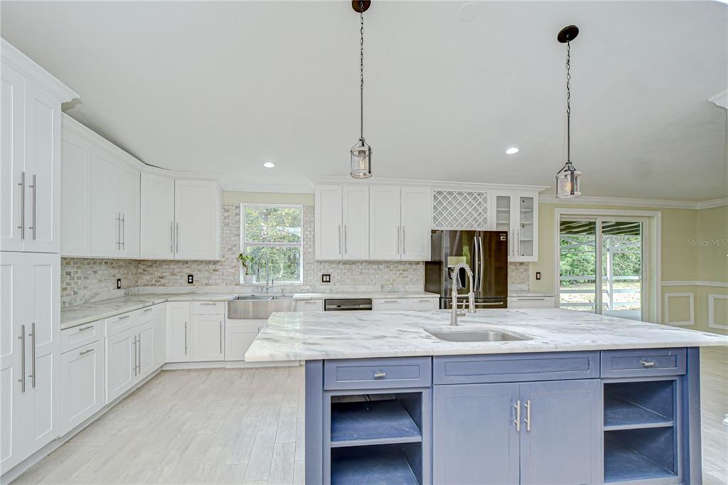 1931 Jaudon Road Dover, FL 33527 - Photo 17 of 50 a kitchen with granite countertop a sink a counter space appliances and cabinets