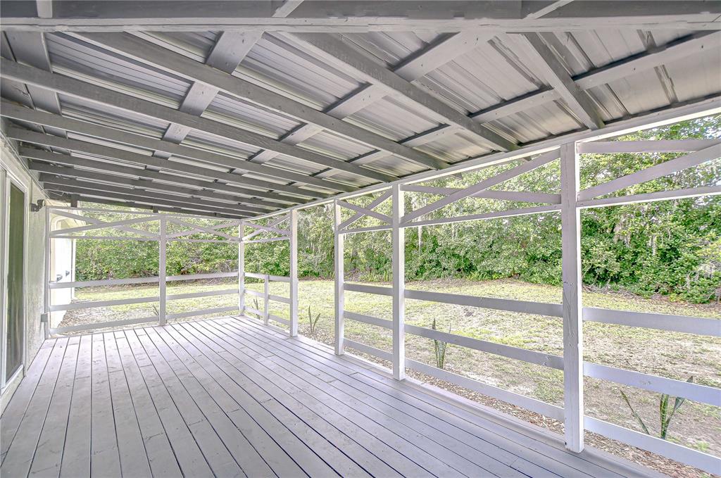 1931 Jaudon Road Dover, FL 33527 - Photo 40 of 50 a view of empty room with wooden floor and outdoor space