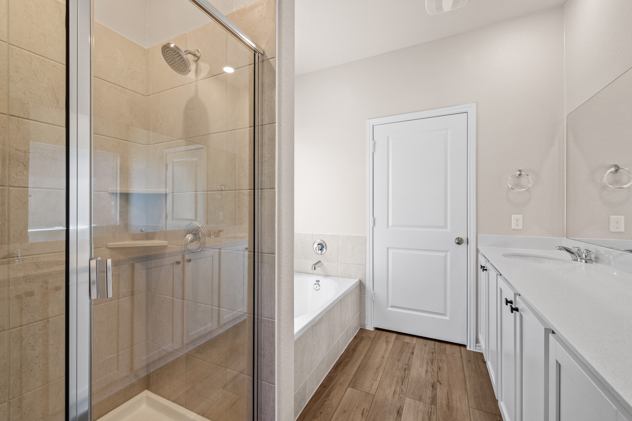 2309 Four Waters Loop Georgetown, TX 78628 - Photo 19 of 40 Bathroom with vanity, a garden tub, a stall shower, and light wood finished floors