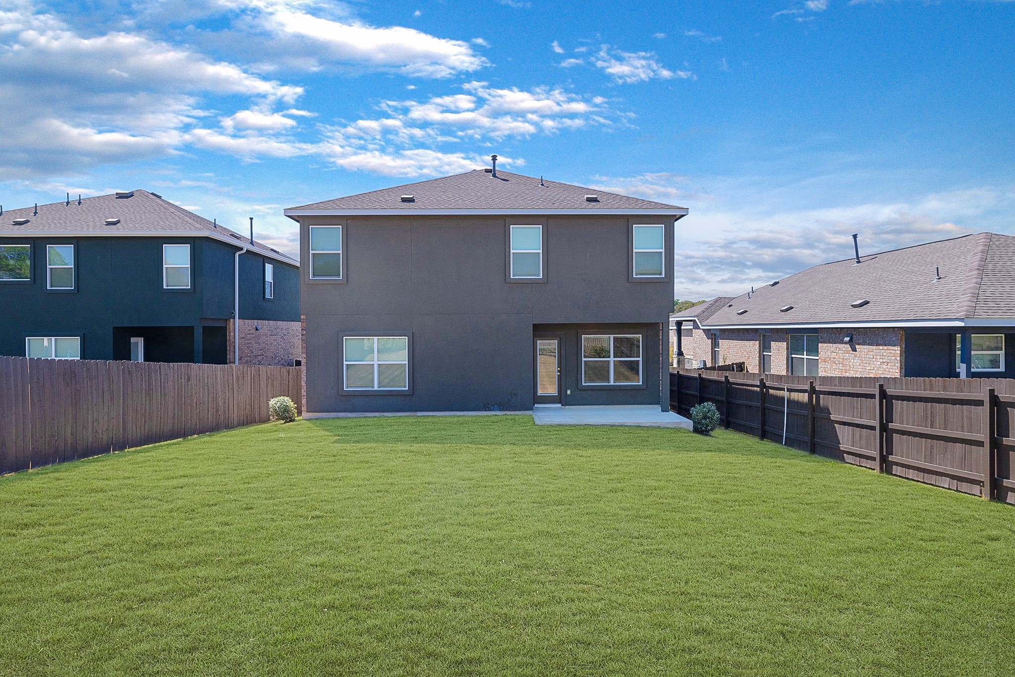 2309 Four Waters Loop Georgetown, TX 78628 - Photo 31 of 40 Back of house featuring a fenced backyard and a patio