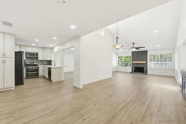 a view of kitchen with furniture and refrigerator