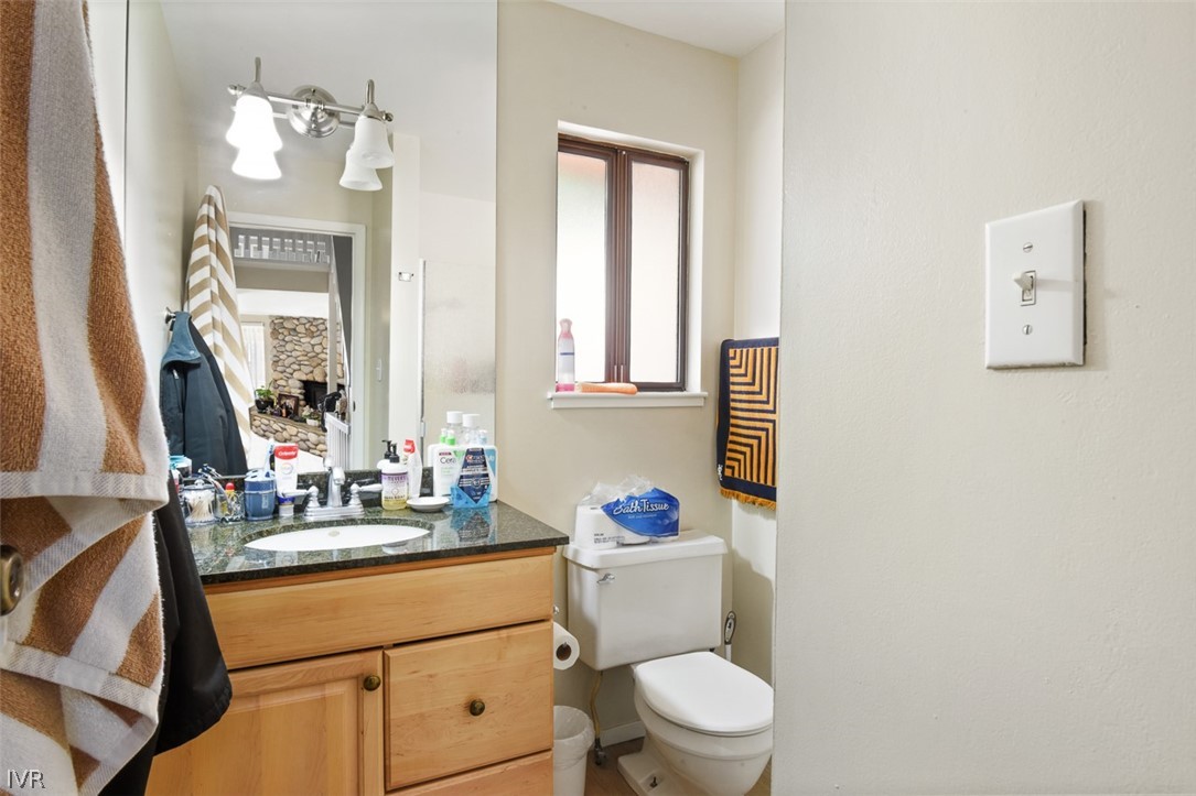 321 Ski Way Northeast, Unit 187 Incline Village, NV 89451 - Photo 16 of 18 a bathroom with a toilet sink and mirror