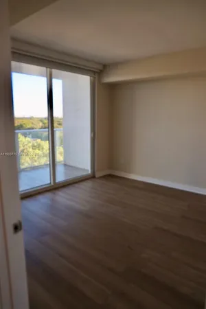 a kitchen with stainless steel appliances granite countertop a sink a stove a refrigerator and island with wooden floor