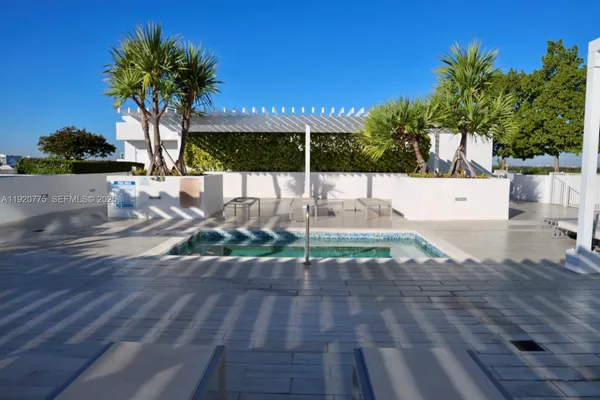 a view of a swimming pool with outdoor seating