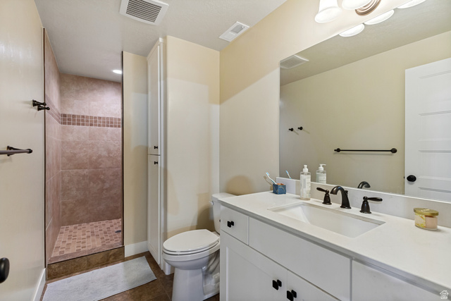 40 Wheeler Road Heber City, UT 84032 - Photo 23 of 41 Walk-in shower with tiled walls and floor, vanity with integrated sink, and an extended countertop