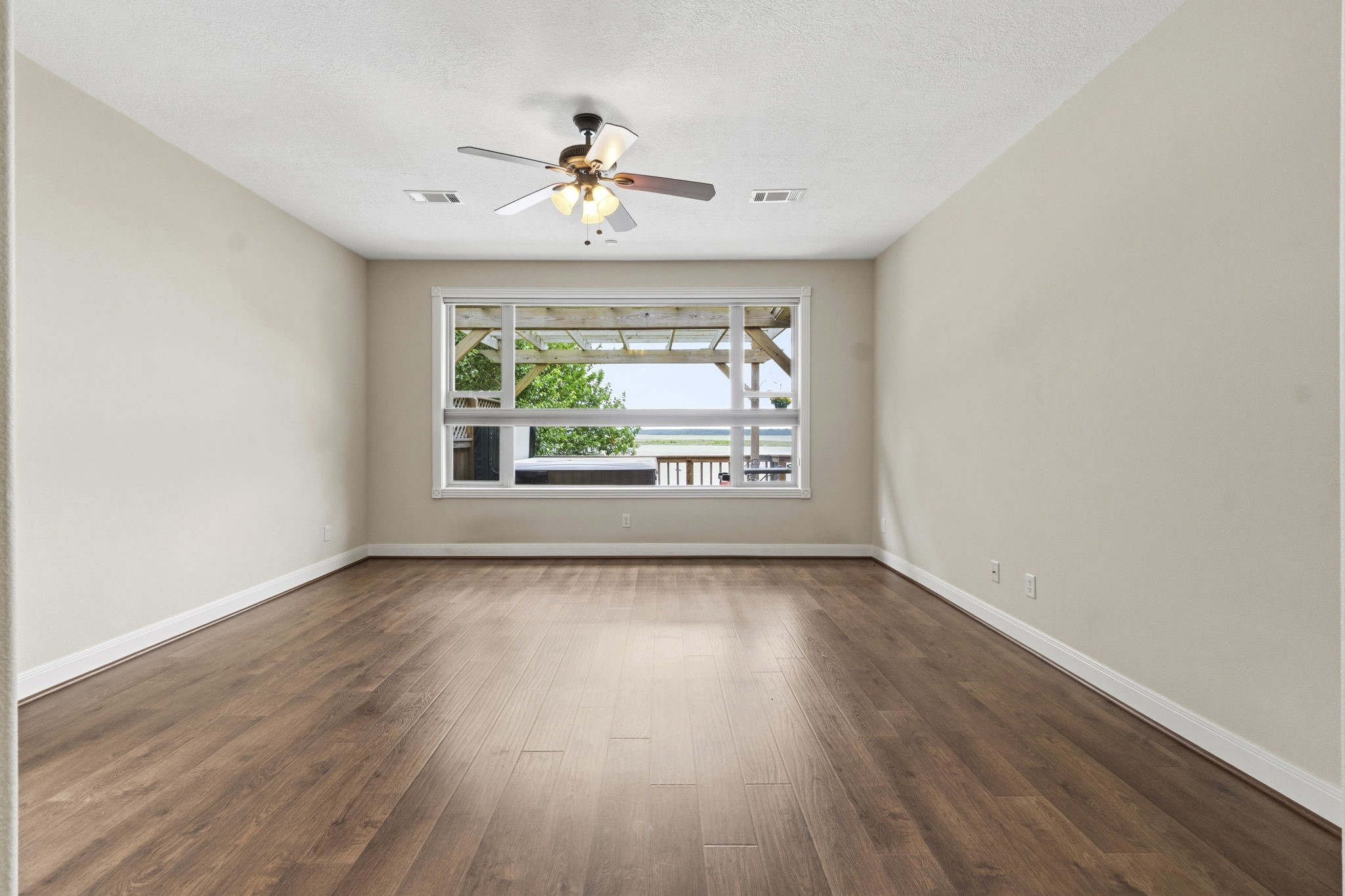 259 Memphis Bell Lane Trinity, TX 75862 - Photo 14 of 50 a view of an empty room with wooden floor and a window
