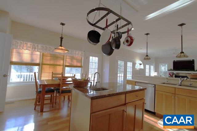 1097 Tilman Road Charlottesville, VA 22901 - Photo 8 of 32 a kitchen with stainless steel appliances granite countertop a stove a sink dishwasher a dining table and chairs with wooden floor