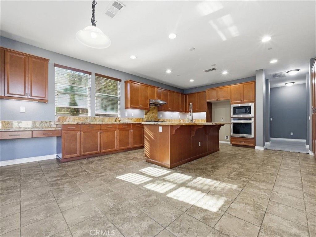 2947 Gilbert Avenue Corona, CA 92881 - Photo 12 of 60 a kitchen with stainless steel appliances granite countertop a stove sink and cabinets