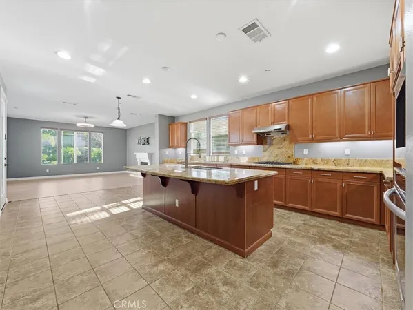 a kitchen with granite countertop cabinets and stainless steel appliances